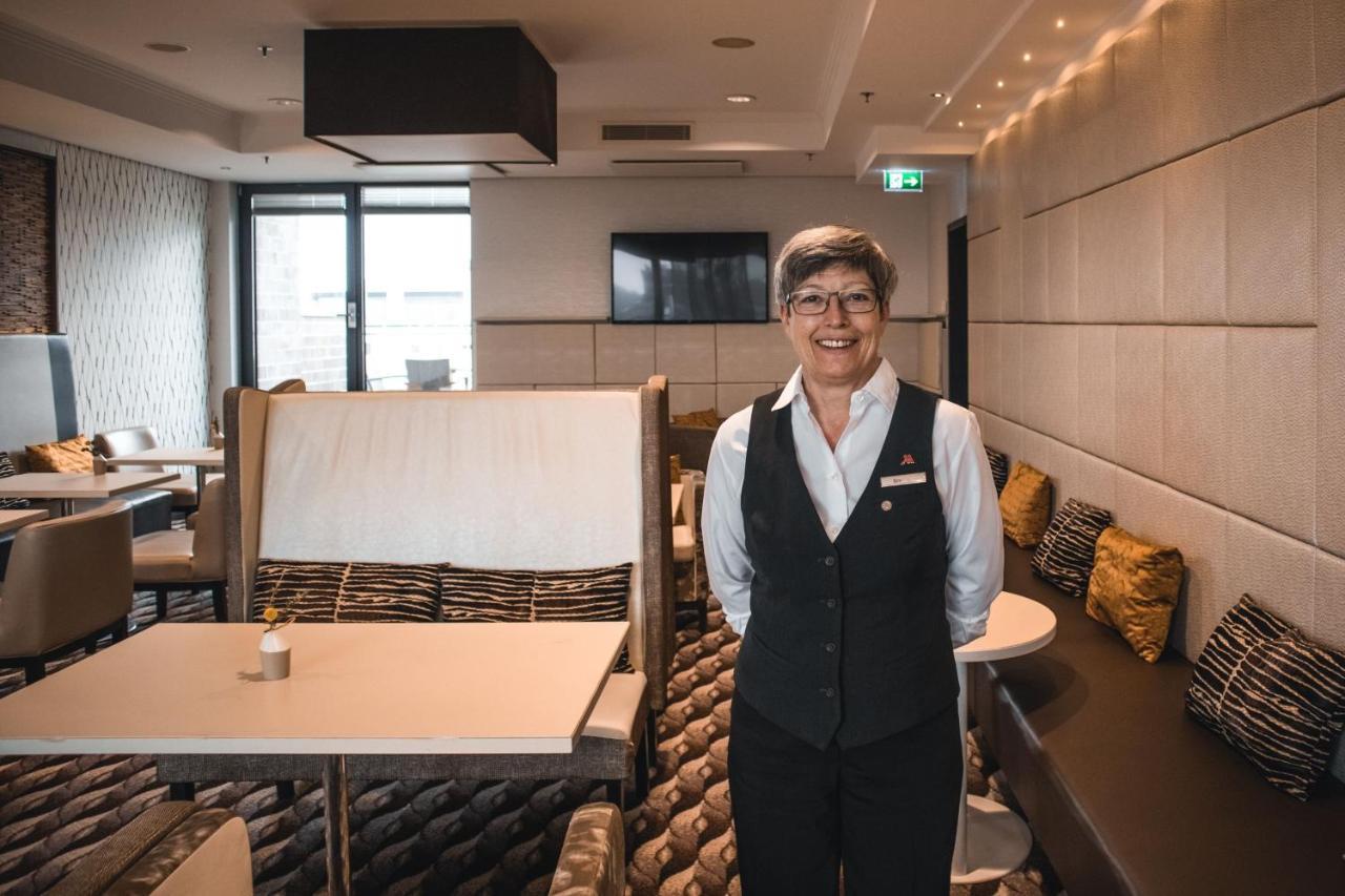 Cologne Marriott Hotel Bagian luar foto A flight attendant in the new uniform